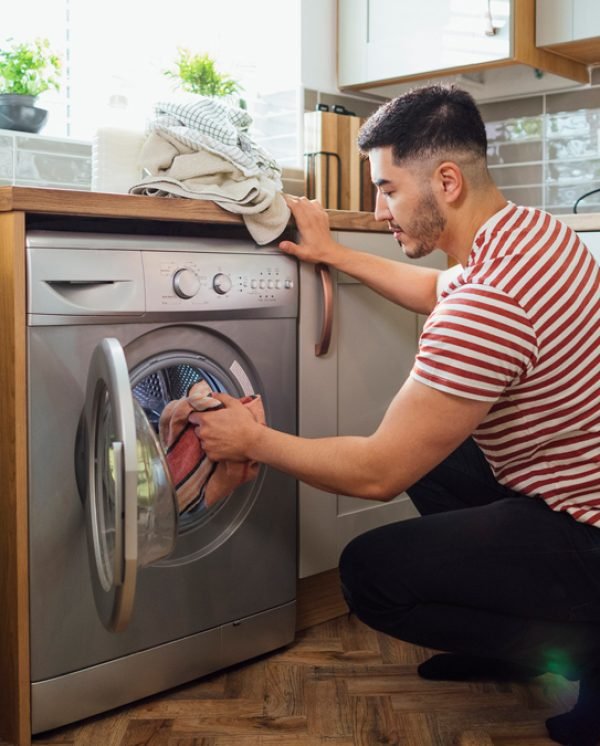 person using a front loader washing machine person using a front loader washing machine
